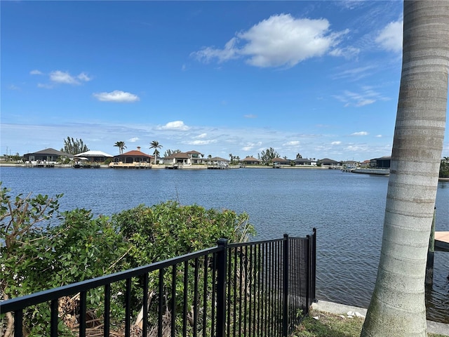 property view of water featuring fence