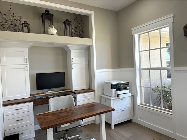 office area with wainscoting and wood finished floors