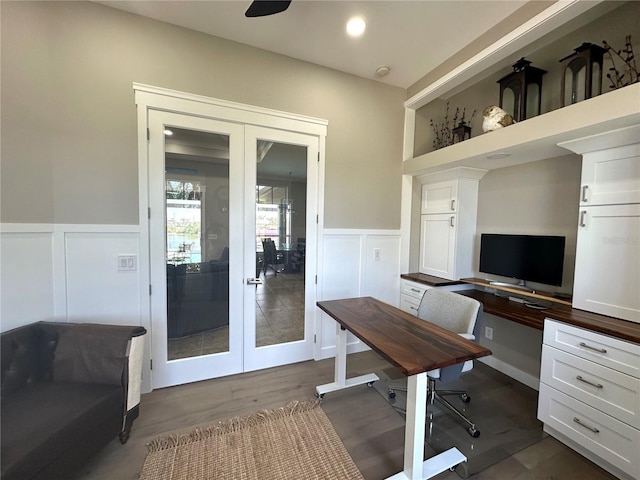 home office featuring wainscoting, dark wood-style floors, and french doors