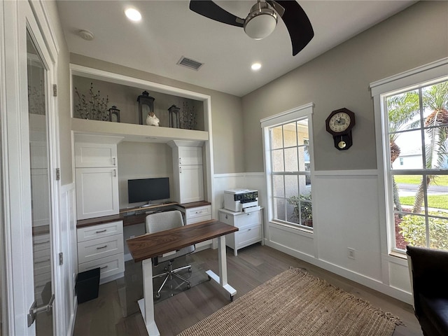 office area featuring a wainscoted wall, recessed lighting, visible vents, dark wood-type flooring, and ceiling fan