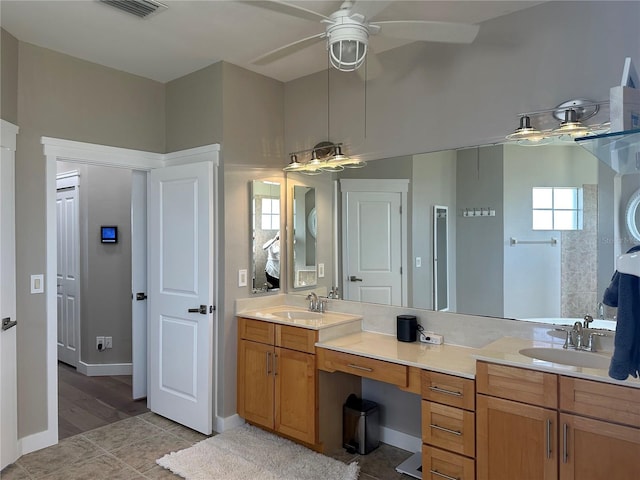 full bathroom with double vanity, a sink, visible vents, and a ceiling fan