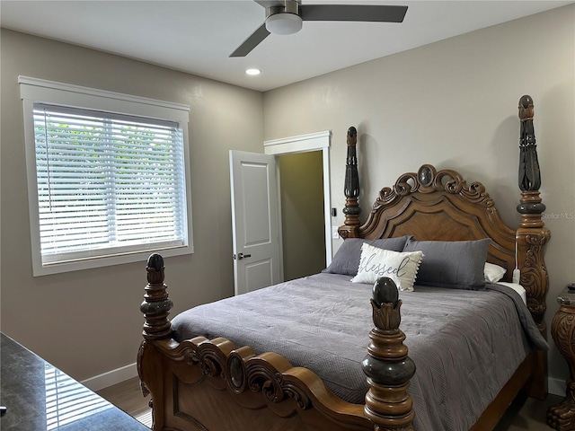 bedroom with baseboards, a ceiling fan, and wood finished floors