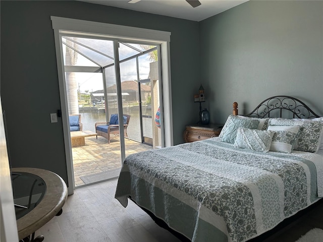 bedroom with access to exterior and a sunroom