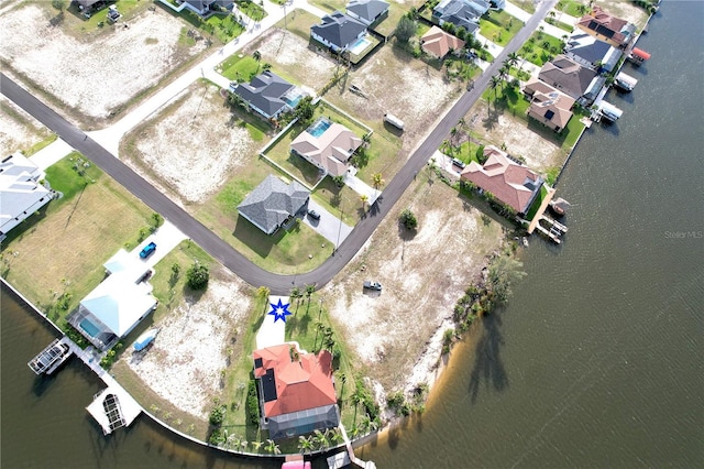 birds eye view of property featuring a residential view and a water view