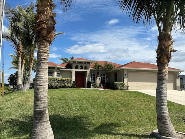 mediterranean / spanish-style home featuring a garage, a front yard, concrete driveway, and stucco siding