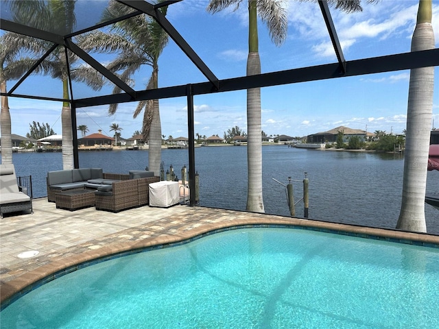 outdoor pool featuring a patio, a water view, and an outdoor living space