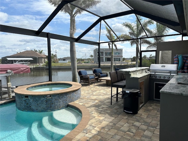 view of patio / terrace with outdoor dry bar, a water view, area for grilling, exterior kitchen, and a lanai