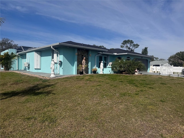 ranch-style house with a garage and a front lawn