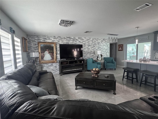 living room featuring a textured ceiling and a wealth of natural light