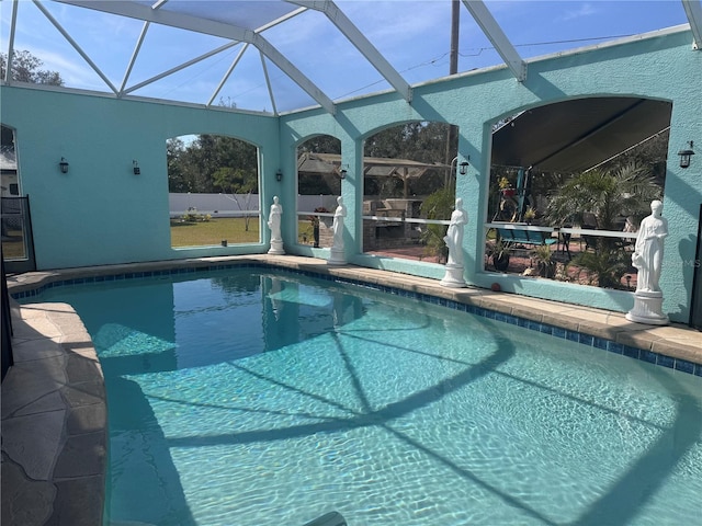 view of swimming pool with glass enclosure