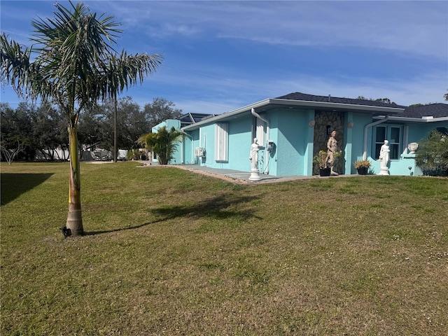 view of property exterior featuring a lawn