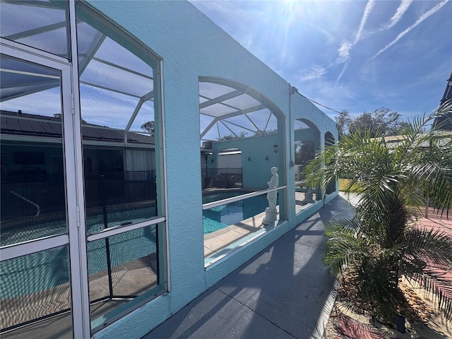 view of swimming pool with a patio and a lanai