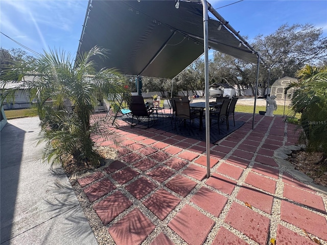 view of patio featuring a storage unit