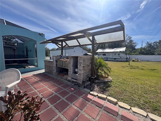 view of patio / terrace with exterior bar, an outdoor kitchen, and a pergola