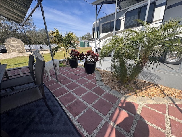 view of patio featuring a shed