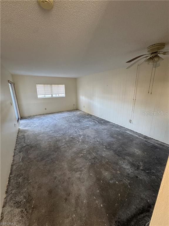 unfurnished room featuring concrete floors and a textured ceiling