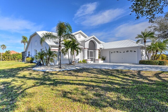 view of front of property featuring a garage and a front yard