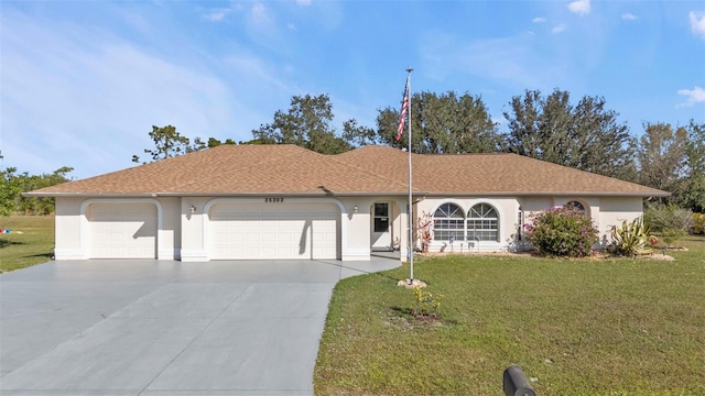 ranch-style house featuring a garage and a front lawn