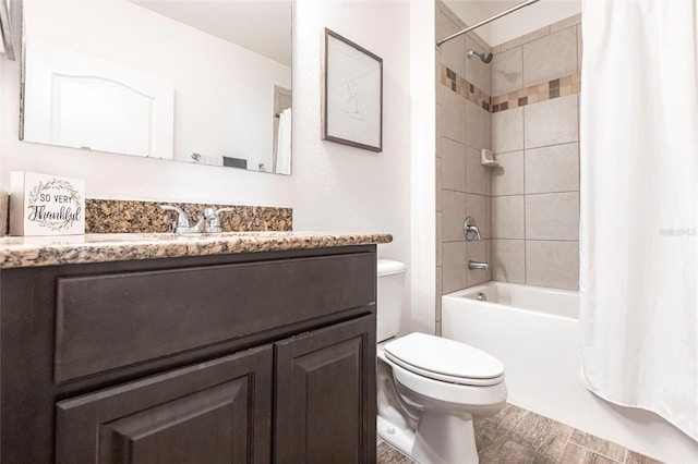 bathroom featuring toilet, shower / tub combo with curtain, and vanity