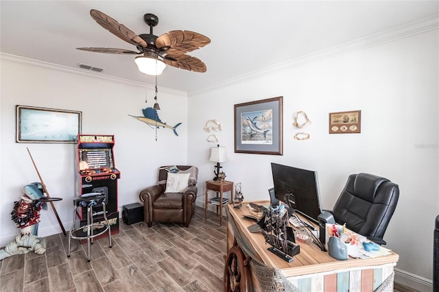 home office with baseboards, visible vents, ceiling fan, wood finished floors, and crown molding