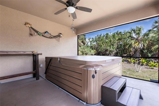 view of patio / terrace featuring a hot tub and ceiling fan