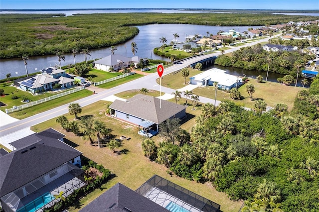 drone / aerial view with a water view and a residential view