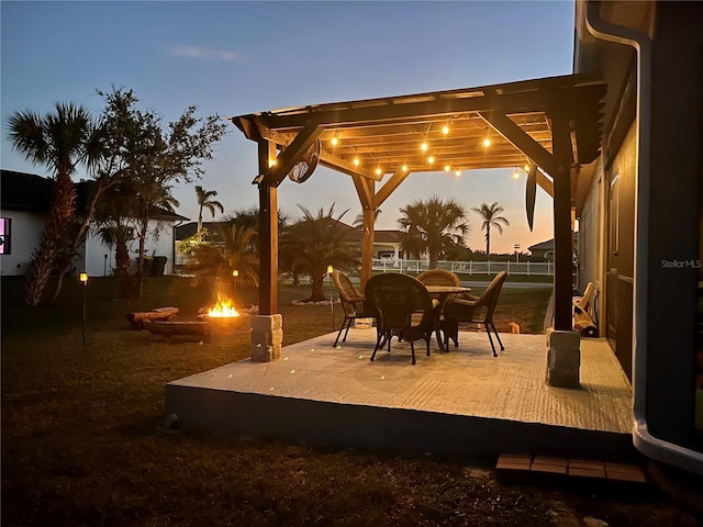 view of patio / terrace featuring fence, a fire pit, and a pergola