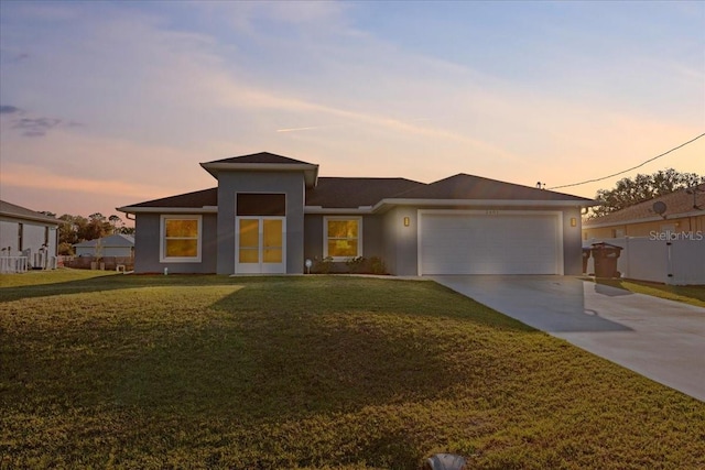 view of front facade with a yard and a garage