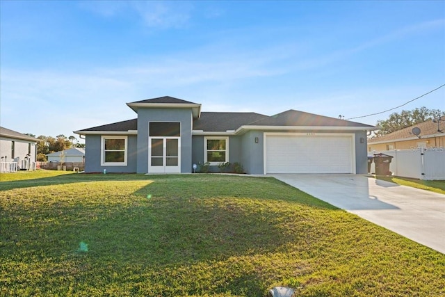 view of front of property with a garage and a front yard