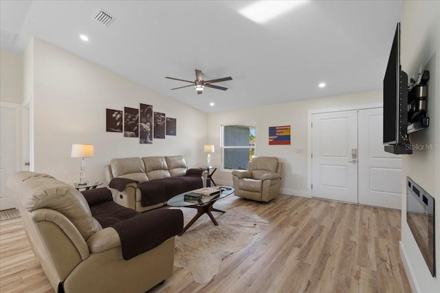 living room with vaulted ceiling, ceiling fan, and light hardwood / wood-style floors