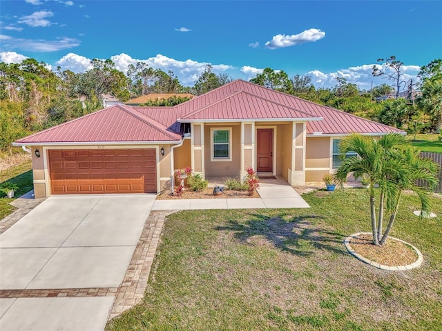 view of front of home with a garage and a front lawn