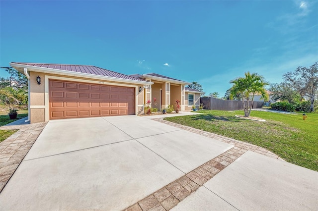 view of front of house with a garage and a front yard