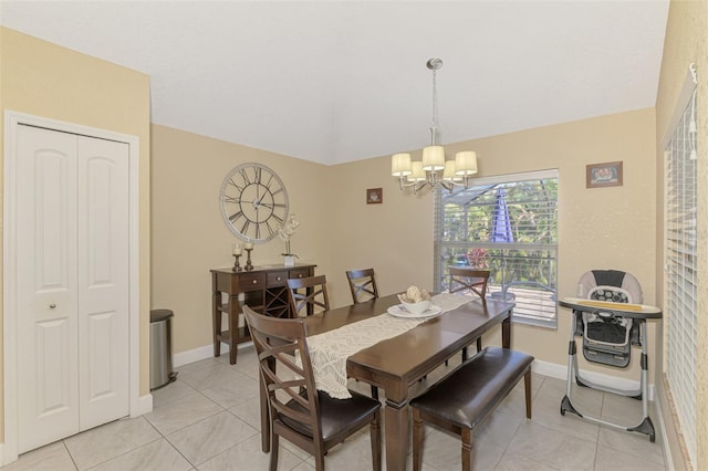 dining space with an inviting chandelier, vaulted ceiling, and light tile patterned floors