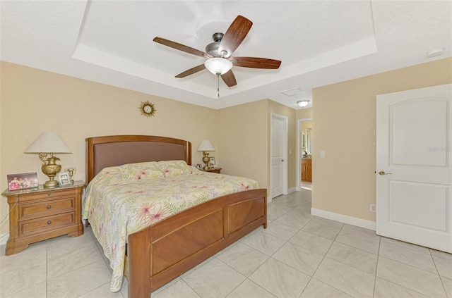 bedroom featuring light tile patterned floors, a tray ceiling, a textured ceiling, and ceiling fan