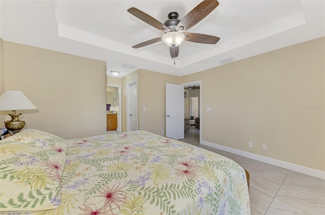 bedroom with a tray ceiling, ceiling fan, and light tile patterned flooring