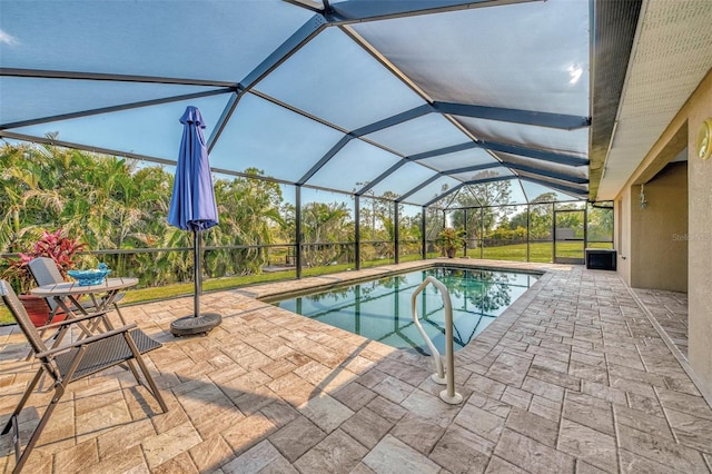 view of pool featuring a patio and glass enclosure