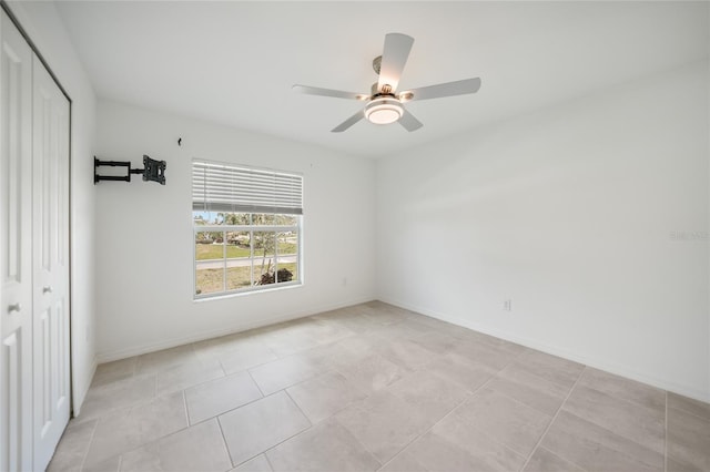 interior space with ceiling fan and a closet