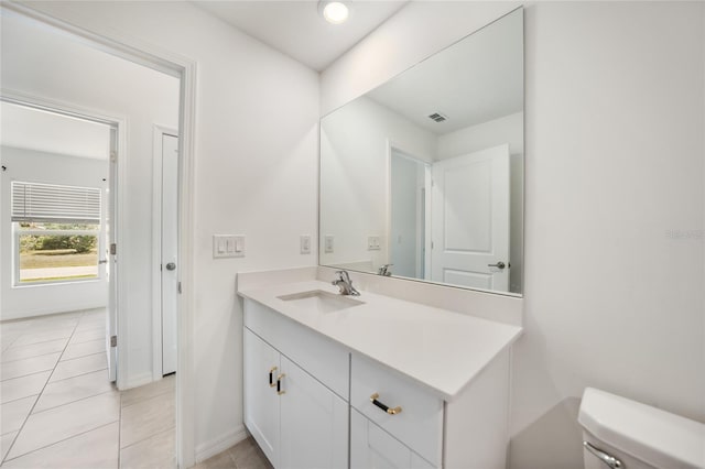 bathroom featuring vanity, toilet, and tile patterned flooring