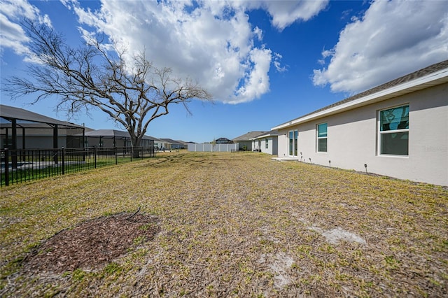 view of yard with glass enclosure