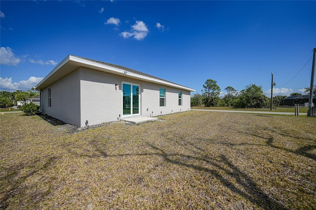 rear view of property with a lawn