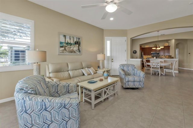 tiled living room featuring ceiling fan