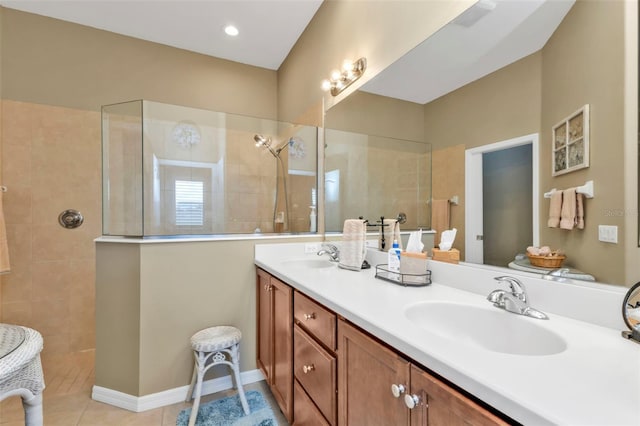 bathroom with vanity, tiled shower, and tile patterned floors