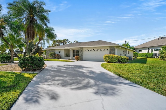 ranch-style home featuring a garage, a front lawn, and central air condition unit