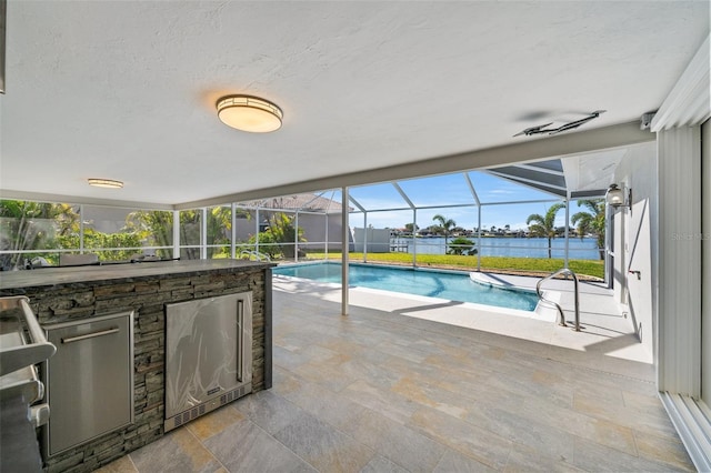 view of swimming pool featuring a bar, a patio, and glass enclosure