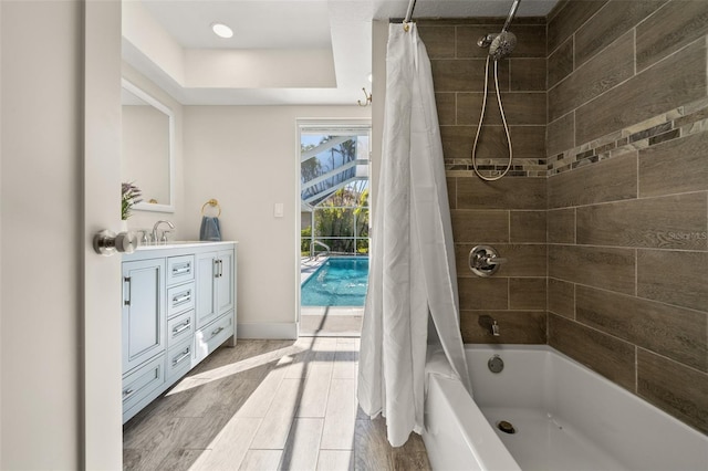 bathroom with shower / tub combo with curtain and vanity