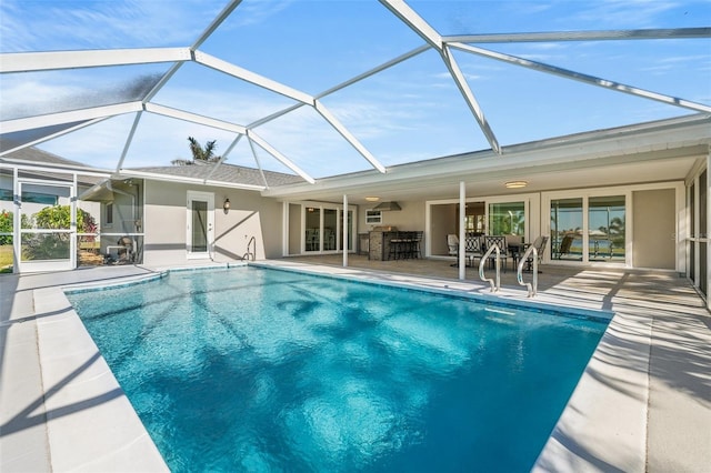 view of swimming pool with a patio area, an outdoor bar, and glass enclosure