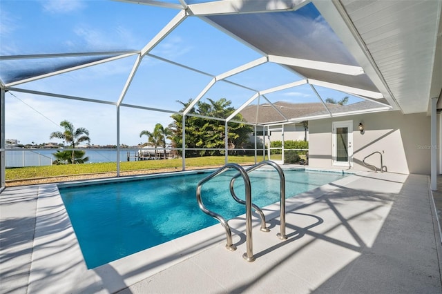 view of swimming pool with a water view, a yard, a patio area, and glass enclosure