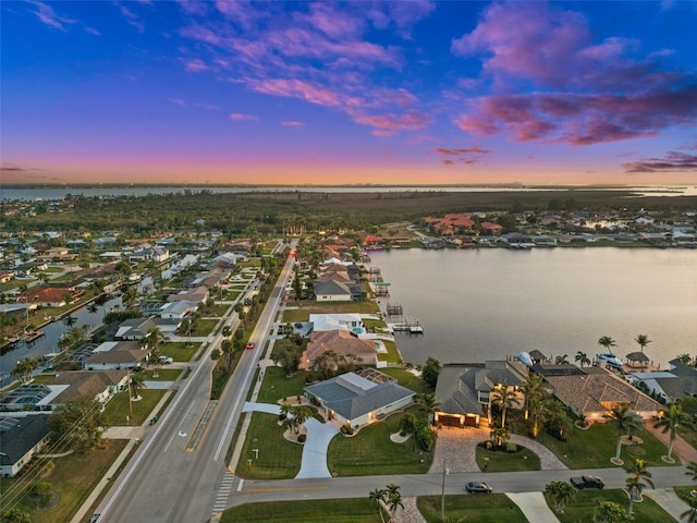 aerial view at dusk with a water view