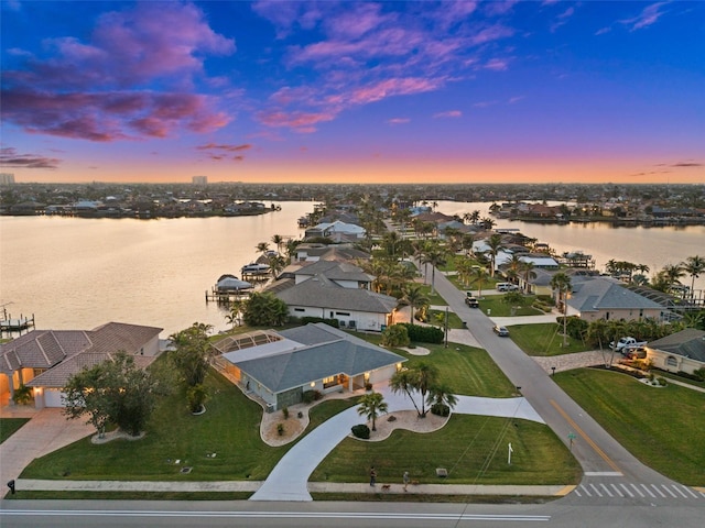 aerial view at dusk with a water view