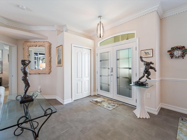 entrance foyer with ornamental molding and french doors